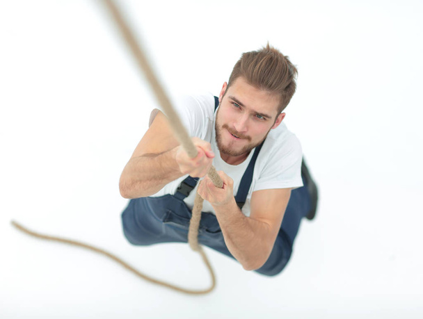 construction worker climbing the rope up. - Valokuva, kuva