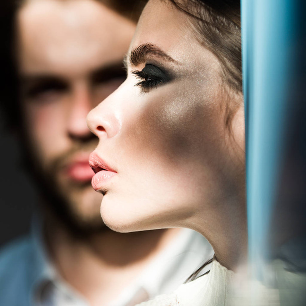 Girlfriend with makeup face skin with blurred boyfriend on background - Fotó, kép