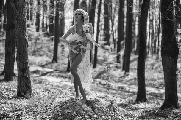 Young woman with goat in forest - 写真・画像