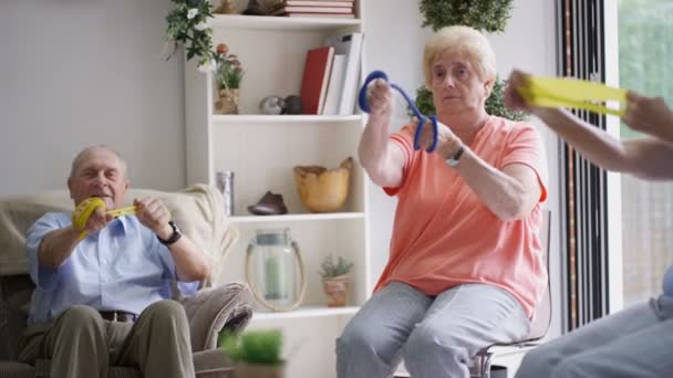 Nurse showing elderly group some exercises in nursing home. - 映像、動画