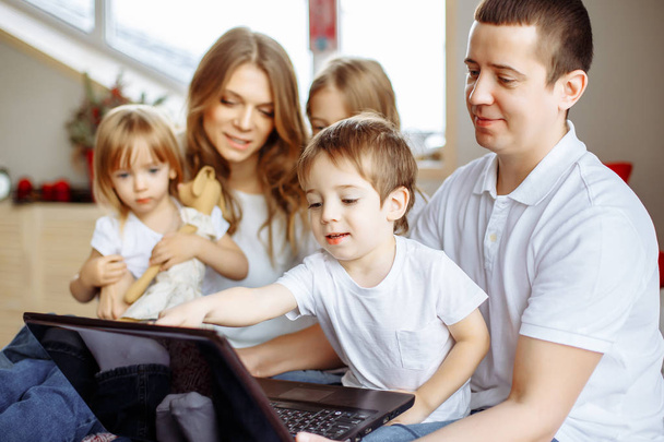 Family concept. Happy family with laptop at home - Фото, изображение