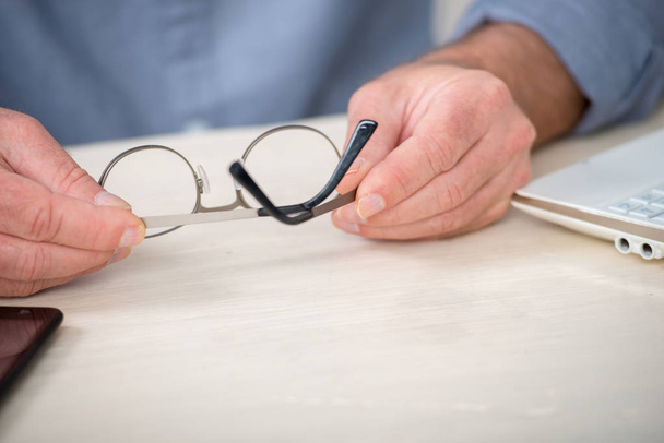 close up of the hands of senior man with glasses - Photo, Image