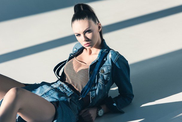 stylish young woman posing in trendy denim clothes - 写真・画像