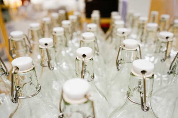 many glass empty bottles stand in a row - Φωτογραφία, εικόνα