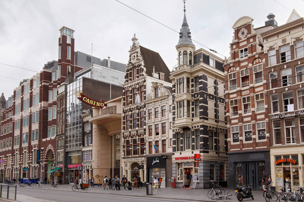 View to the old historical buildings on the Damrak street in Amsterdam.  - Photo, Image