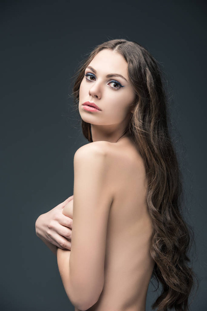 beautiful naked girl with long hair, isolated on grey - Foto, imagen