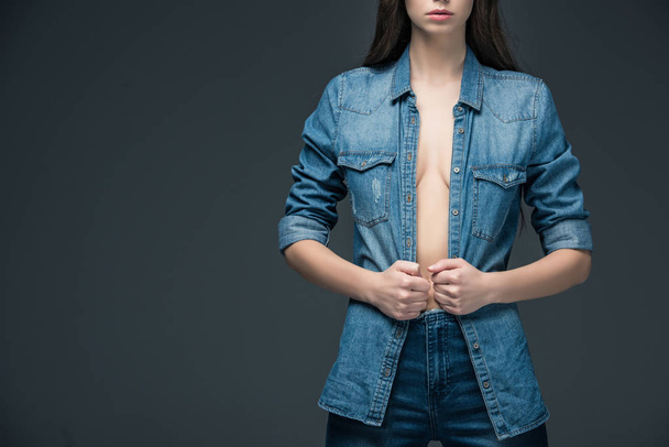 cropped view of woman posing in trendy denim clothes, isolated on grey  - Zdjęcie, obraz