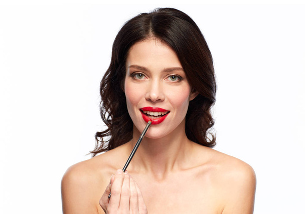 beautiful woman with make up brush for lipstick - Fotó, kép