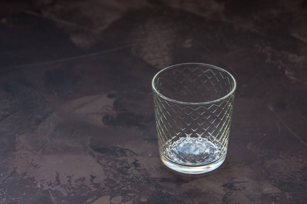Empty glass beaker on a dark background - Photo, Image