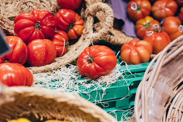 closeup view of raw tomatoes in wicker baskets - 写真・画像