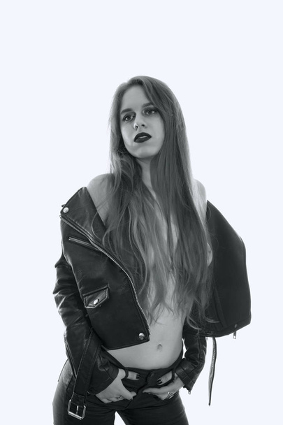 Young woman posing sexy with a leather jacket on white background - Foto, Bild