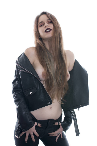 Young woman posing sexy with a leather jacket on white background - Fotó, kép