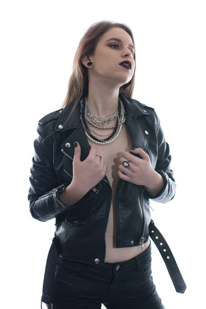 Young woman posing sexy with a leather jacket on white background - Valokuva, kuva