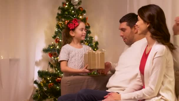 happy family with christmas present at home - Filmagem, Vídeo