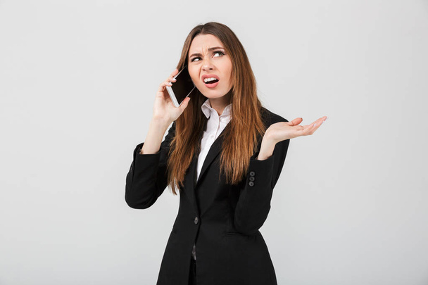 Angry displeased lady talking on smartphone isolated - Photo, image