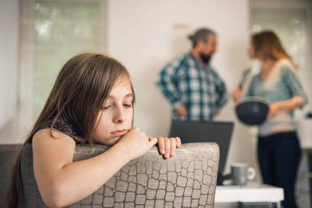 Traumatized daughter listening parents arguing at home - Foto, Imagen