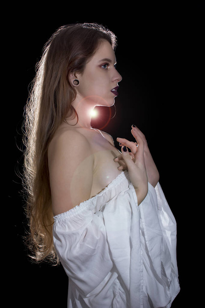 Young woman with white dress posing on black background - Photo, Image