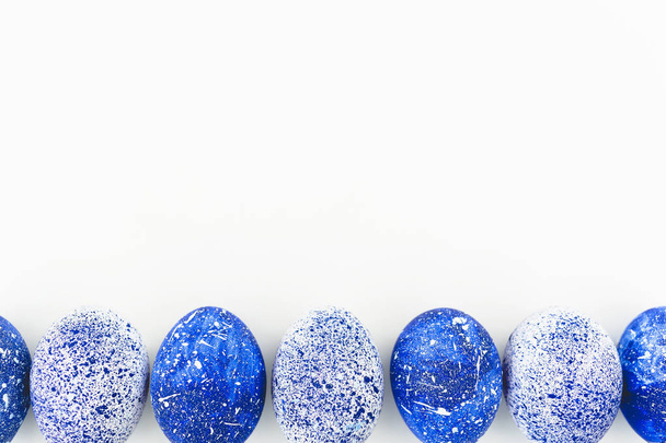 Blue Speckled Easter Eggs on white background. Flat lay. Top view - Photo, image