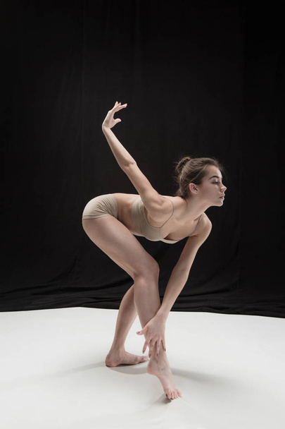 Young teen dancer on white floor background. - Фото, изображение