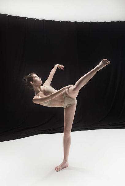Young teen dancer on white floor background. - Foto, Bild