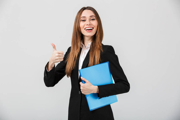 Portrait of a cheerful businesswoman dressed in suit - Φωτογραφία, εικόνα