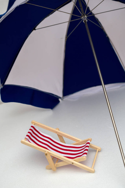 Red striped deck chair under a canopy - Photo, image