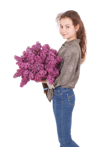 Girl teenager standing with lilac in hands - Photo, Image