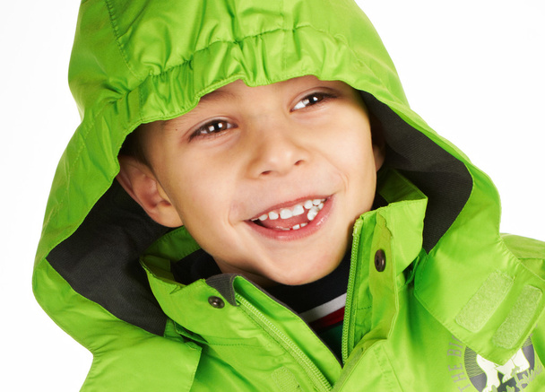 Laughing boy dressed in a warm winter jacket - Valokuva, kuva