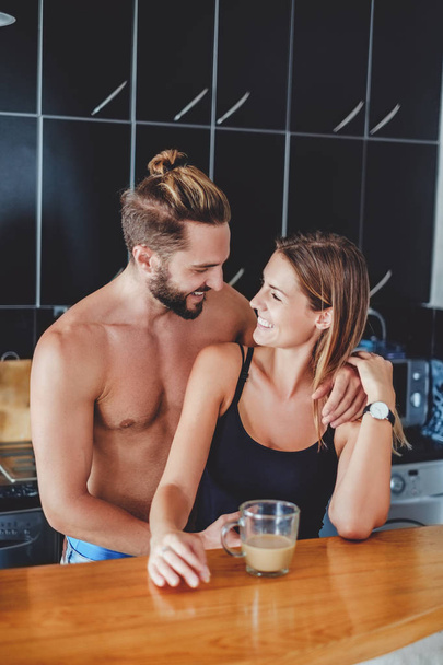Couple in love hugging in the kitchen - Photo, Image
