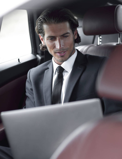man working on laptop while sitting in the car - Foto, Imagem