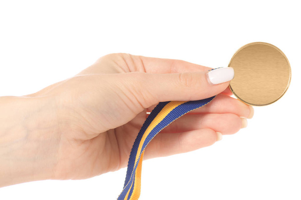 Золота медаль на стрічці в руці
 - Фото, зображення