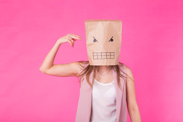 Concept of negative emotions - Angry woman with a paper bag on his face. - Photo, Image