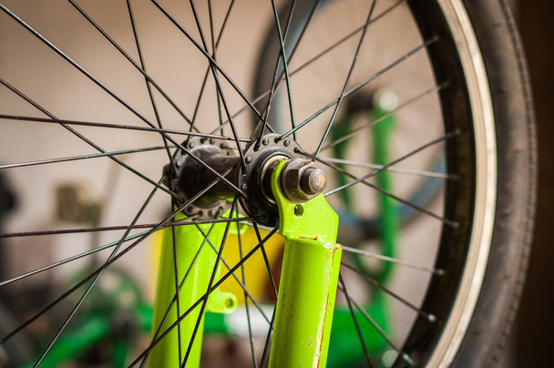 Close up of selective focus of the wheel of the bike in a workshop - Фото, изображение