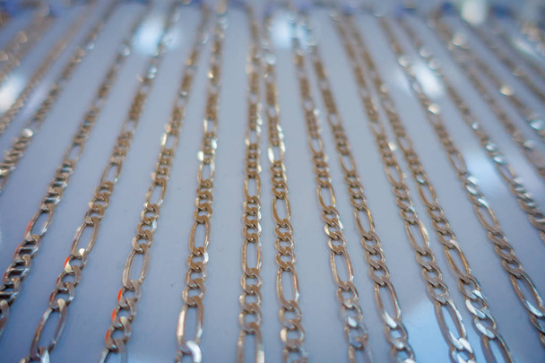 Close up of selective focus of a silver necklace inside of a souvenir store, in a small and beautiful town in Kaua, in Mexico - Fotografie, Obrázek