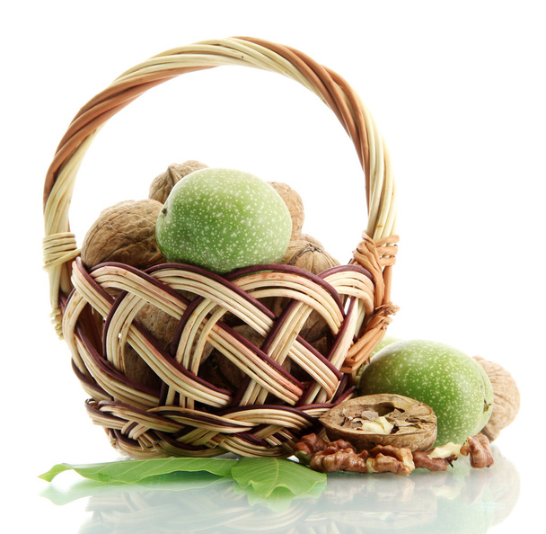 walnuts with green leaves in basket, isolated on white - Photo, Image