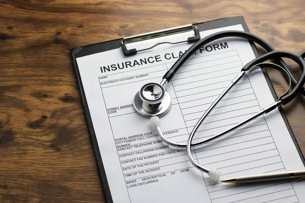 health insurance claim form with stethoscope on wood table selec - Foto, afbeelding