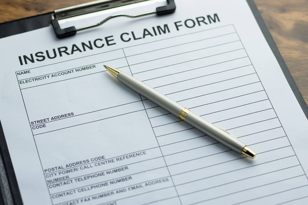 Insurance claim form with pen on  wooden table. selective focus - Photo, Image