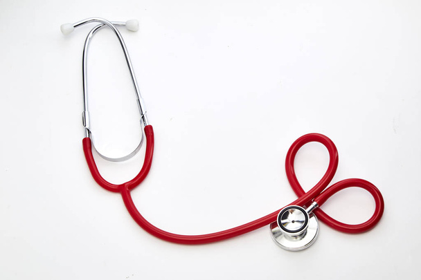 Červené stočené stetoskop izolovaných na bílém pozadí - Fotografie, Obrázek