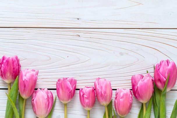 pink tulip flower on wood background - Фото, изображение
