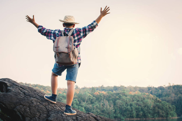 Asian boy backpack in nature , Relax time on holiday concept travel,selective and soft focus,tone of hipster style - 写真・画像