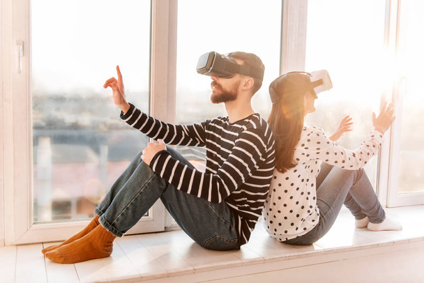 Attractive young couple spending time in VR - Fotó, kép