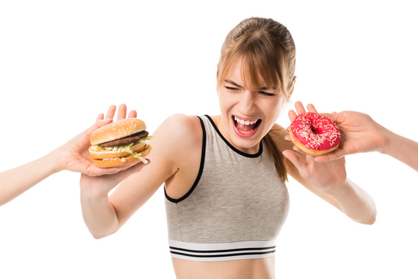 jonge slanke vrouw weigeren van junk food geïsoleerd op wit - Foto, afbeelding