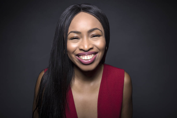 Black female model on a dark background with happy expressions. - Photo, Image