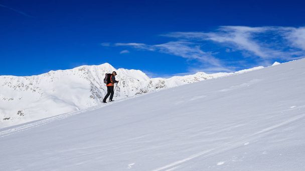 mountaineers uphill with snowshoes towards the Foisc lace, in the Lepontine Alps (Switzerland) - Photo, image