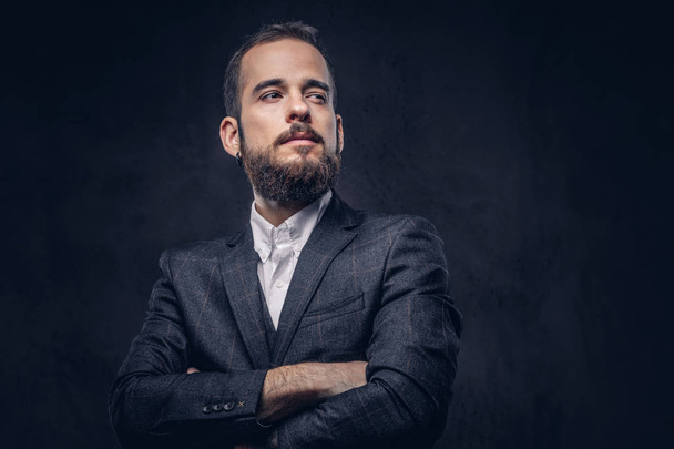 Portrait of handsome bearded stylish male, wearing an elegant suit on a dark background. - Photo, Image
