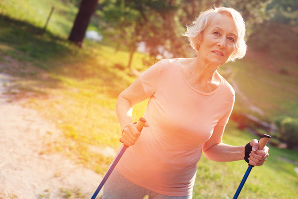 Pleasant elderly woman with crutches - Zdjęcie, obraz