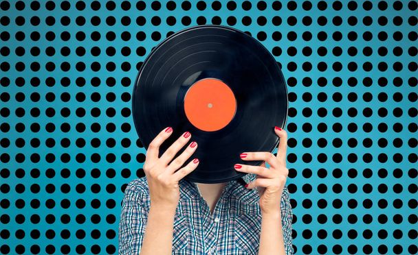 Woman holding a vinyl record  - Фото, зображення