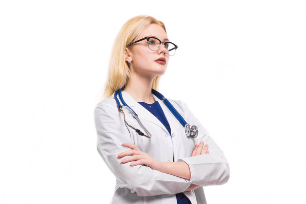 Young confident female doctor with stethoscope standing with arms crossed  - Photo, Image