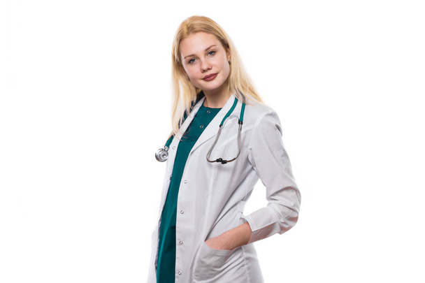 Young confident doctor with hands in pockets looking at camera - Фото, зображення