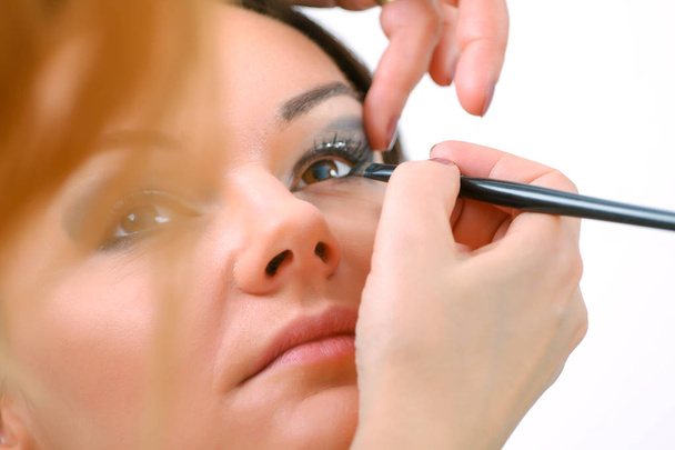 Professional Make-up artist doing glamour model makeup at work - Photo, Image